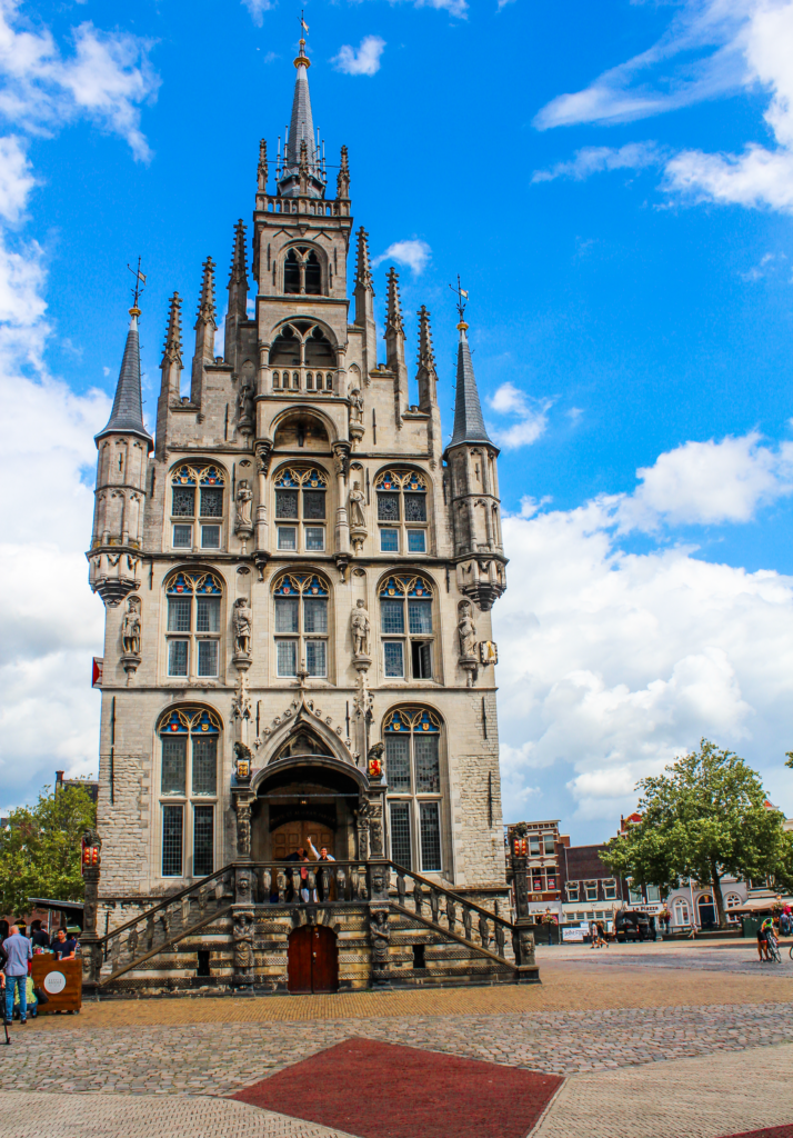 Stadhuis i Gouda, byens historiske rådhus, ikonisk bygning på Markt-pladsen, gotisk arkitektur fra 1400-tallet, en af Hollands ældste rådhusbygninger, seværdigheder i Gouda, smukke detaljer og røde skodder, kendt for sit mekaniske klokkespil med figurer, oplevelser i Gouda centrum, kulturelt vartegn i Sydholland, populære bryllupslokaler og fotospot, stolt symbol på byens historie og selvstændighed, must-see for arkitektur- og historieinteresserede, stadhuis som hjertet af Gouda.